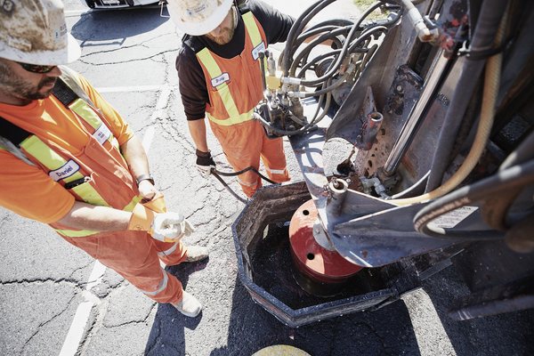 OE hydrovac crew daylighting a buried utility connection